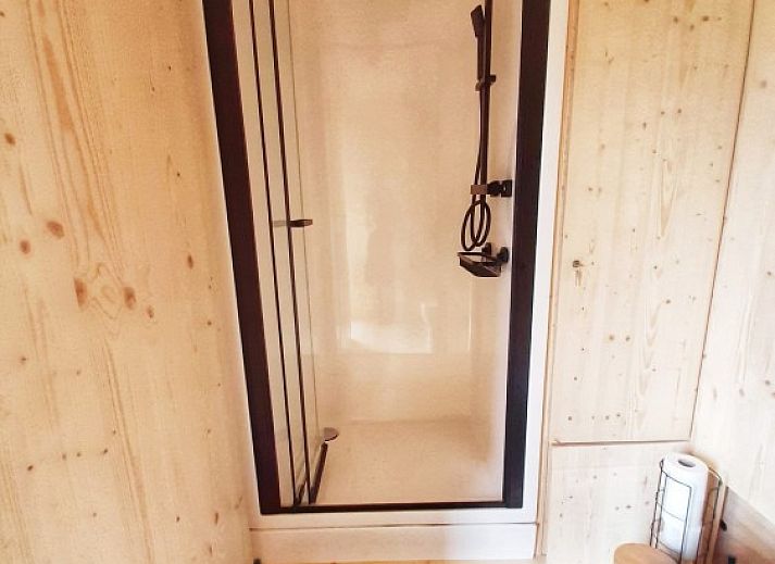 Cozy interior of Black Pearl vacation home in Moerzeke, East Flanders, with dining and sleeping area.