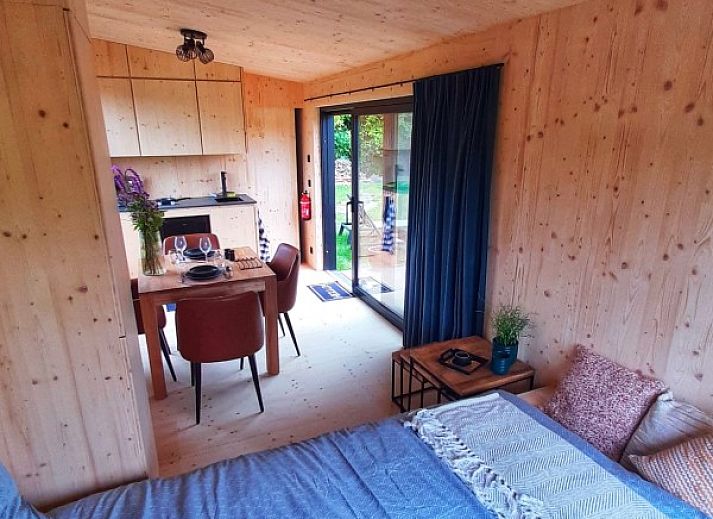 Veranda of Black Pearl vacation home in Moerzeke, East Flanders, overlooking quiet pond.