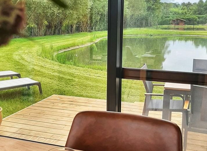 Bedroom in Black Pearl vacation home, Moerzeke, East Flanders, with large windows and views of nature.
