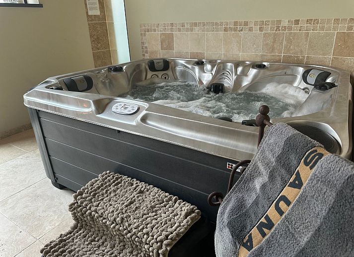 Relax in the luxurious wellness area of Holiday Home Einzigartiger Wellness-Bauernhof in Wichelen, East Flanders, with jacuzzi and fireplace.