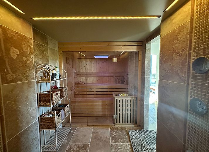 Cozy indoor area of Holiday Home Einzigartiger Wellness-Bauernhof in Wichelen, East Flanders with fireplace and garden view.