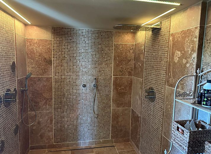 Cozy indoor area of Holiday Home Einzigartiger Wellness-Bauernhof in Wichelen, East Flanders with fireplace and garden view.