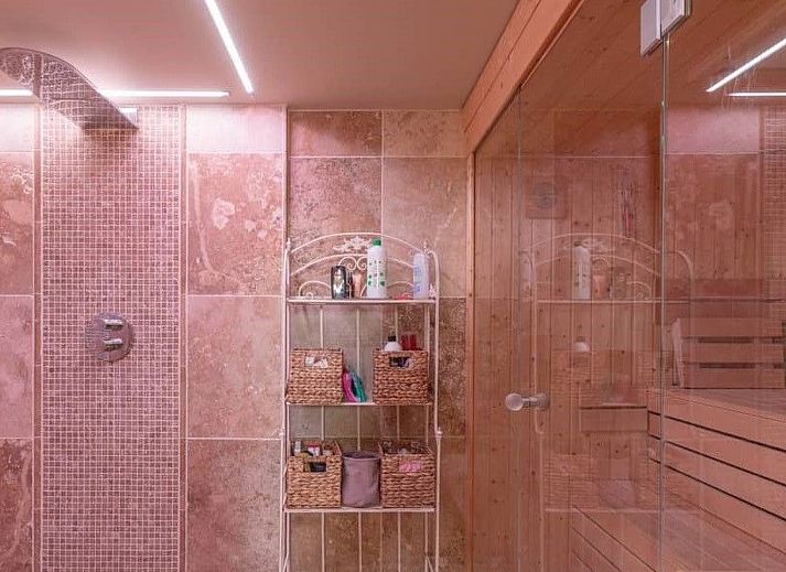 Cozy indoor area of Holiday Home Einzigartiger Wellness-Bauernhof in Wichelen, East Flanders with fireplace and garden view.