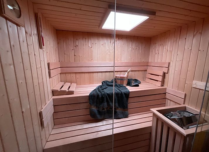 Cozy indoor area of Holiday Home Einzigartiger Wellness-Bauernhof in Wichelen, East Flanders with fireplace and garden view.