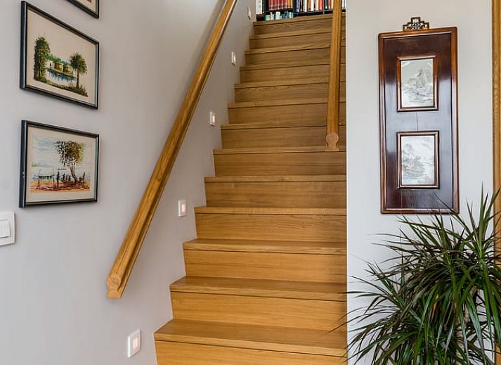 Gemuetliches Wohnzimmer in Cottage in Sint-Laureins, Ferienhaus in Ostflandern, mit bequemer Sitzecke und Blick auf die gruene Landschaft.