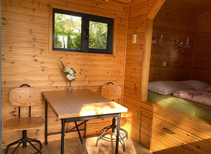 Veranda of Cottage in Merksplas, vacation accommodation in Antwerp surrounded by trees and nature.