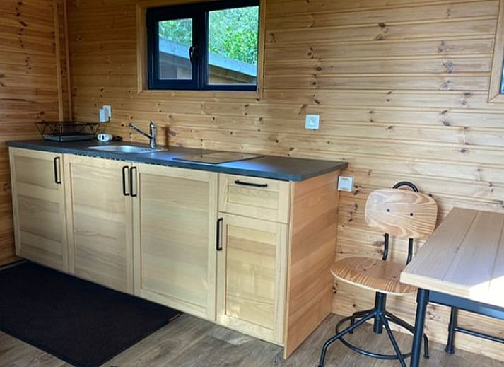 Veranda of Cottage in Merksplas, vacation accommodation in Antwerp surrounded by trees and nature.