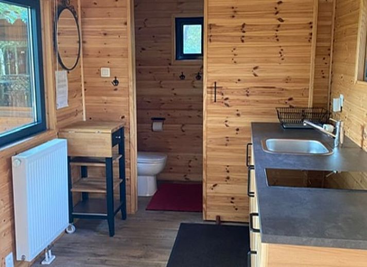 Veranda of Cottage in Merksplas, vacation accommodation in Antwerp surrounded by trees and nature.