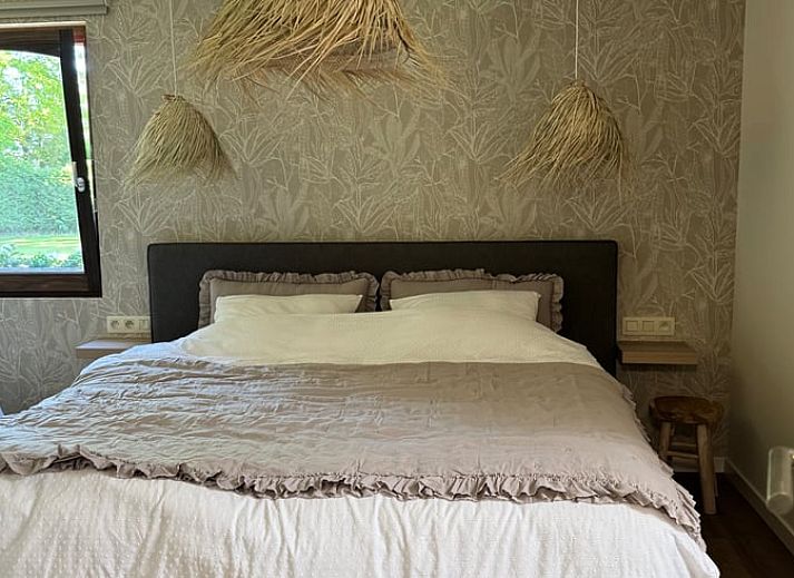 Vacation home in Merksplas, Antwerp, offers an inviting bedroom with a rustic feel for a relaxing stay.