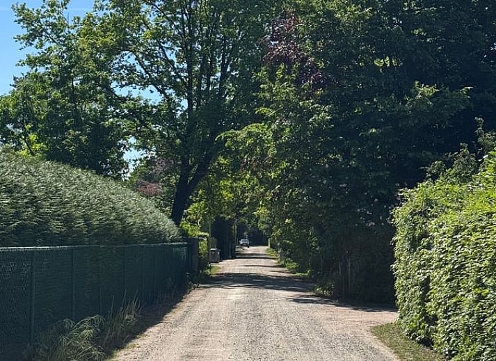 Vacation home in Merksplas, Antwerp, offers an inviting bedroom with a rustic feel for a relaxing stay.