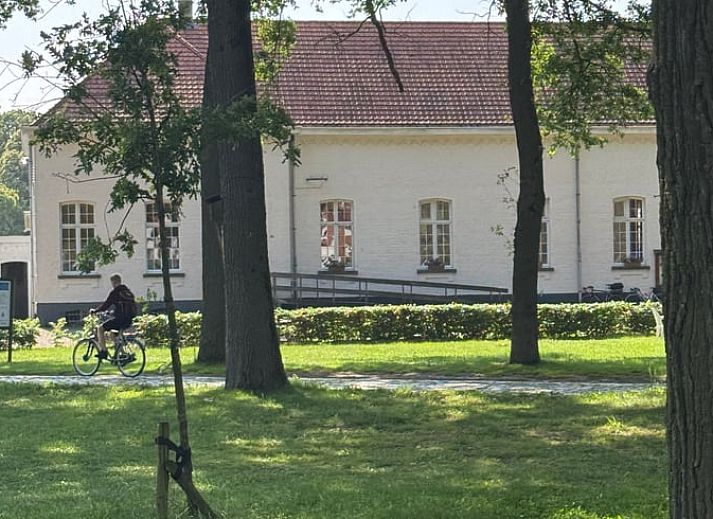 Vacation home in Merksplas, Antwerp, offers an inviting bedroom with a rustic feel for a relaxing stay.