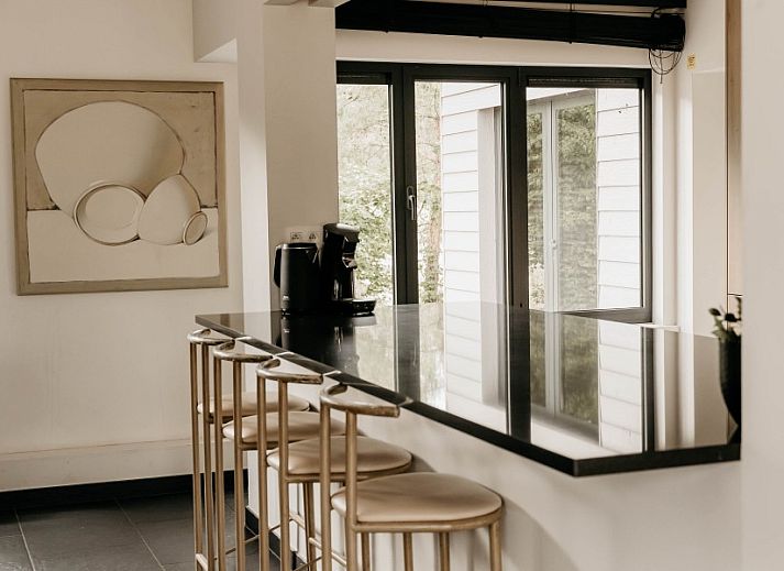 Gemuetliches Wohnzimmer im NatuRauw in Mol, Antwerpen, mit bequemer Sitzecke und grossen Fenstern.