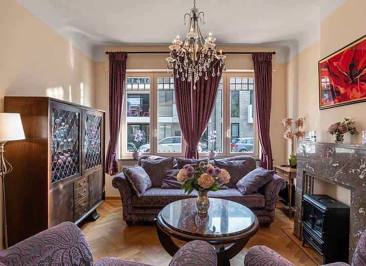 Cozy living room of Holiday Home Jasmine in Mol, Antwerp, with lots of light and access to the terrace for a relaxing stay.