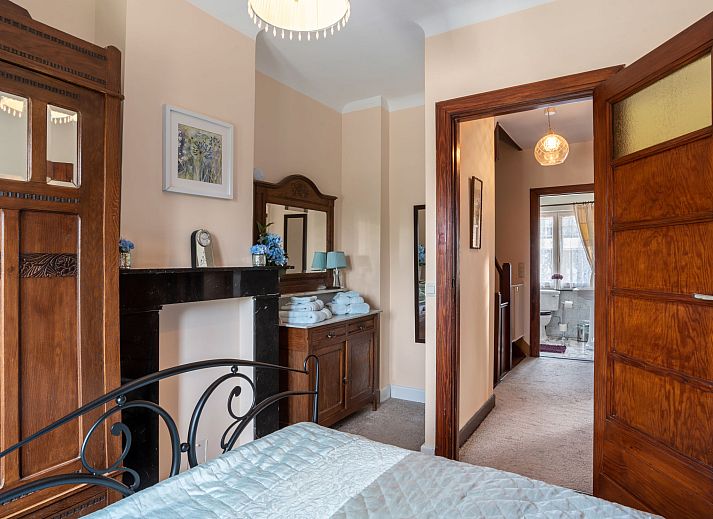 Elegant dining room at Holiday Home Jasmine in Mol, Antwerp with classic wooden furniture and garden views.