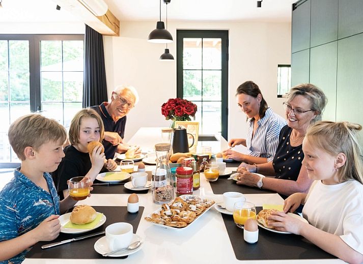 Fassade von Mushoeve in Zoersel, Antwerpen, Ferienhaus mit charmanter weisser Fassade und roten Dachziegeln.