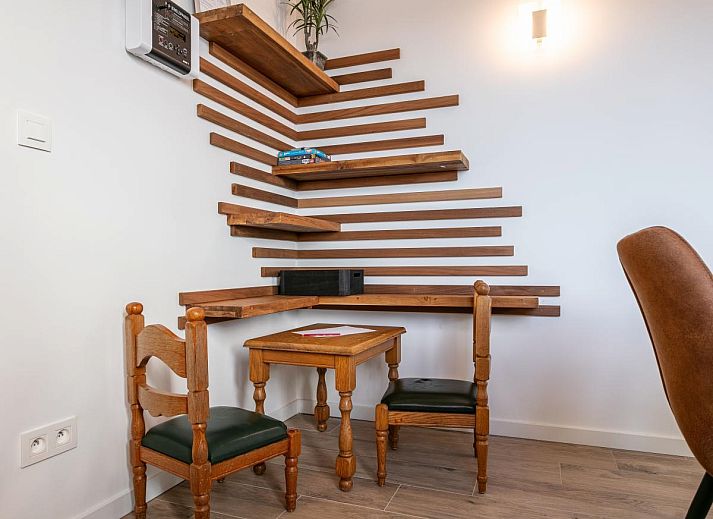 Cozy living room in Lindehoeve vacation home, Turnhout, with comfortable seating and wooden beams.