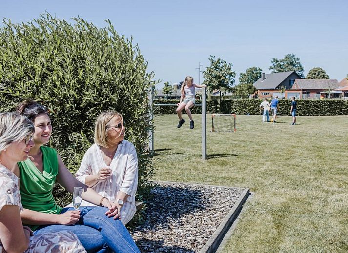 Child-friendly playground at Driehoekshoeve vacation home, Kasterlee, Antwerp with wooden play equipment.