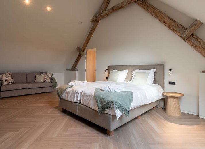 Atmospherically lit exterior of Holiday Home in Kasterlee, Antwerp, Belgium, surrounded by green nature at dusk.