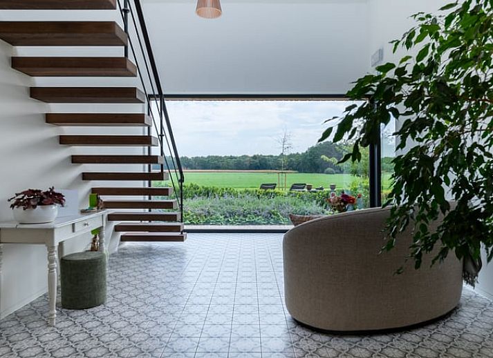 Cozy illuminated terrace at Holiday Home in Kasterlee, Antwerp, Belgium, surrounded by peaceful nature and beautiful evening scenery.