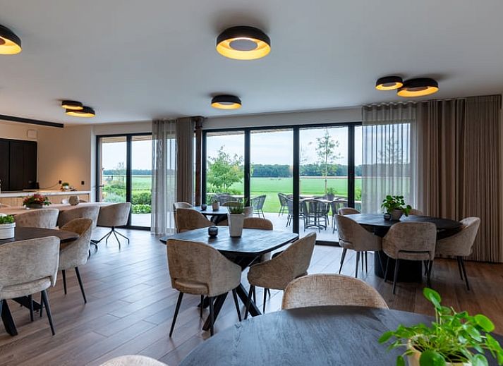 Cozy illuminated terrace at Holiday Home in Kasterlee, Antwerp, Belgium, surrounded by peaceful nature and beautiful evening scenery.