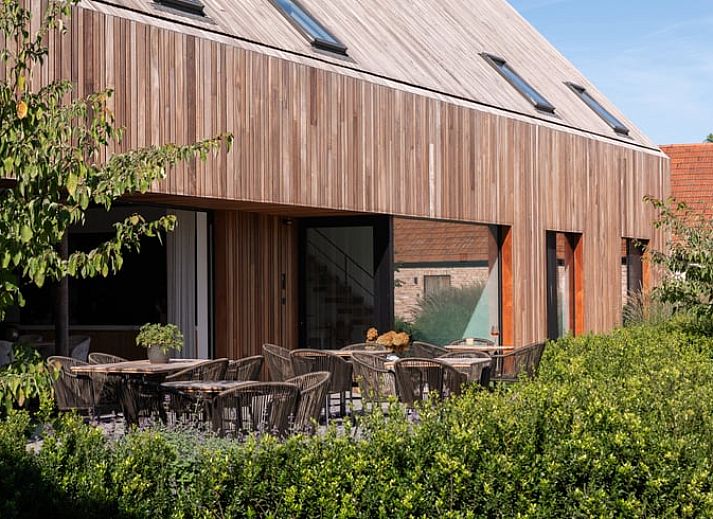 Cozy illuminated terrace at Holiday Home in Kasterlee, Antwerp, Belgium, surrounded by peaceful nature and beautiful evening scenery.