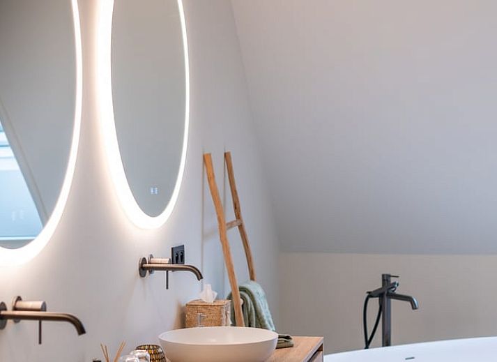 Cozy illuminated terrace at Holiday Home in Kasterlee, Antwerp, Belgium, surrounded by peaceful nature and beautiful evening scenery.