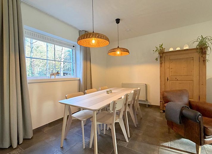 Cozy living room in Lierelodge vacation home, Oud-Turnhout, with wood stove and view of the green garden from the comfortable sitting area.