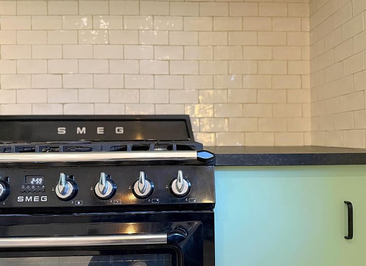 Stylish living room of Lierelodge vacation home in Oud-Turnhout, Antwerp, overlooking the terrace and surrounding nature.