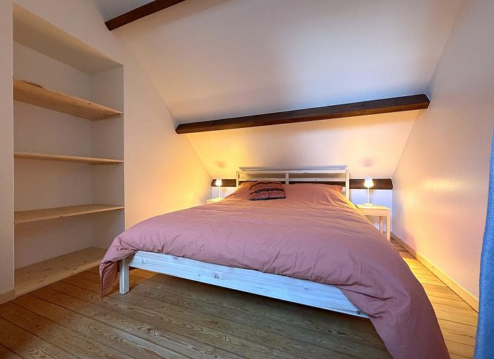 Cozy dining room in Lierelodge vacation home, Oud-Turnhout, Belgium, with wooden furniture and views of the wooded area.