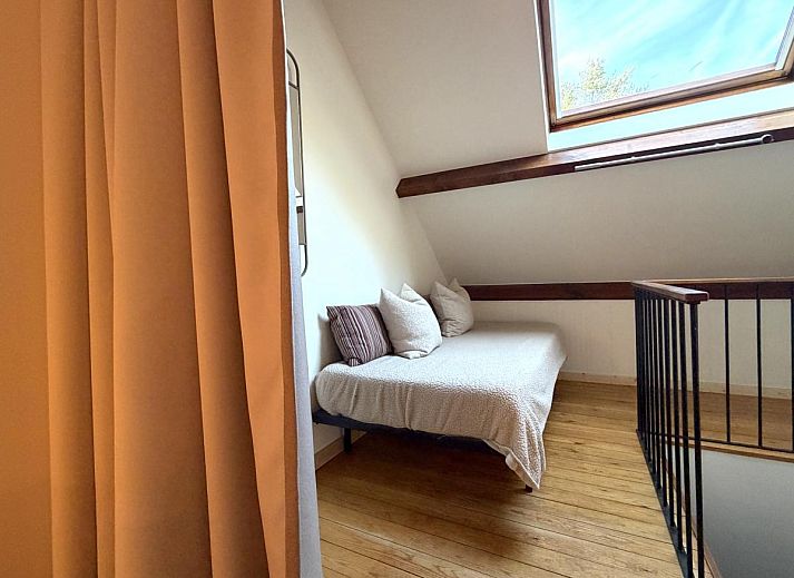 Cozy dining room in Lierelodge vacation home, Oud-Turnhout, Belgium, with wooden furniture and views of the wooded area.