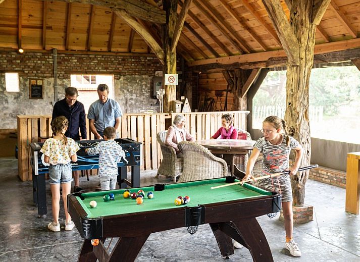 Geraeumiger Innenbereich mit langem Esstisch im Ferienhof Hannekentas, einem Ferienhaus in Essen, Belgien.
