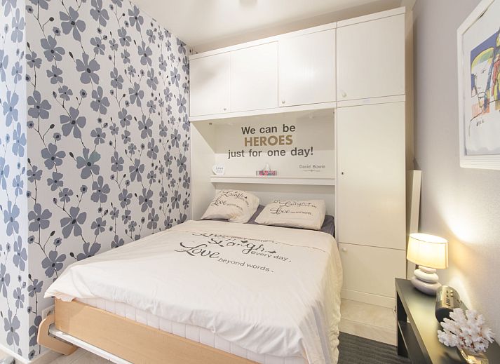 Cozy indoor area of Apartment Bowie with shared pool in De Haan, Antwerp, Belgium, with dining area and balcony views.