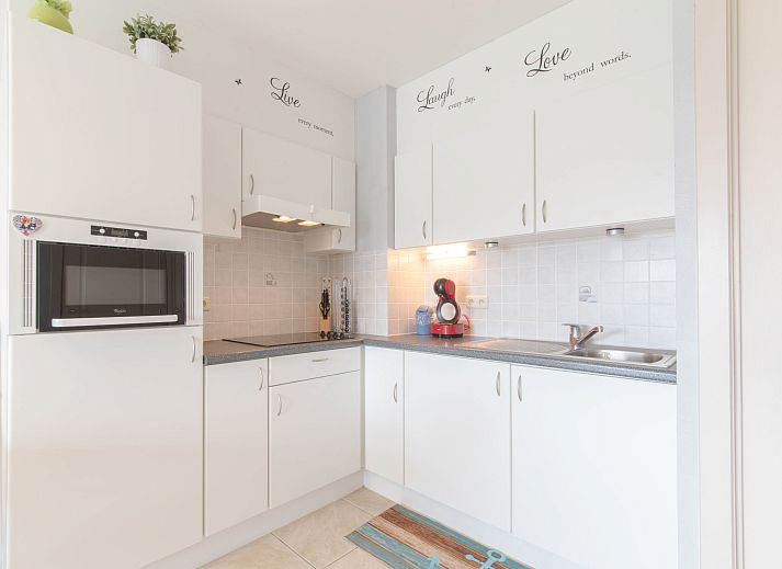 Cozy indoor area of Apartment Bowie with shared pool in De Haan, Antwerp, Belgium, with dining area and balcony views.