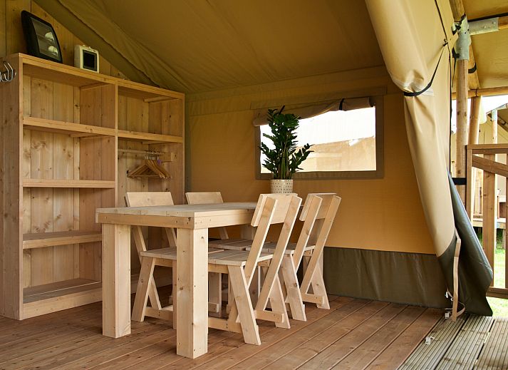 Interior of Safari tent incl. sanitary facilities in Lichtaart, Antwerp, Belgium. Cozy glamping lodge with kitchen and dining area.