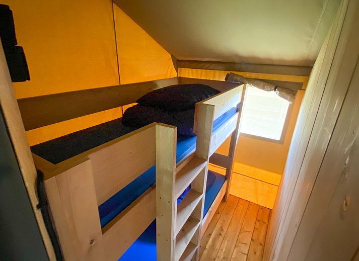 Interior of Safari tent incl. sanitary facilities in Lichtaart, Antwerp, Belgium. Cozy glamping lodge with kitchen and dining area.