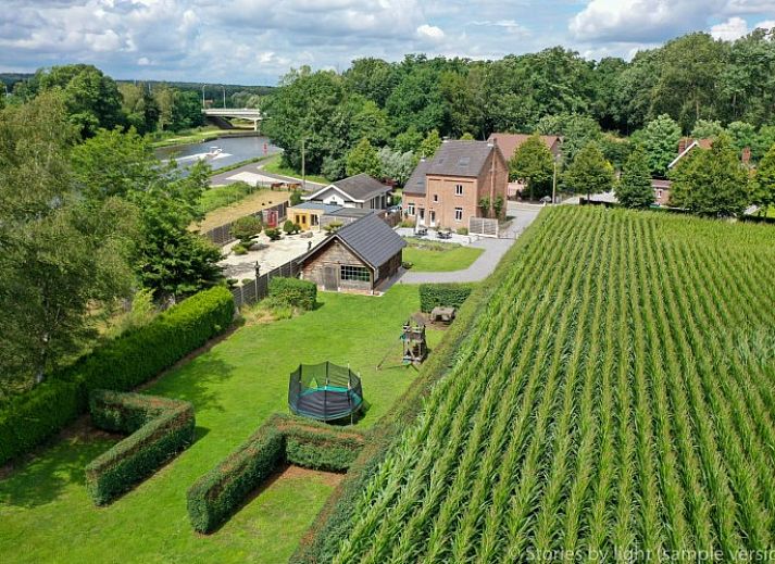 Charming vacation home Tivoli in Dilsen-Stokkem, Limburg, Belgium, surrounded by green nature and rustic architecture.