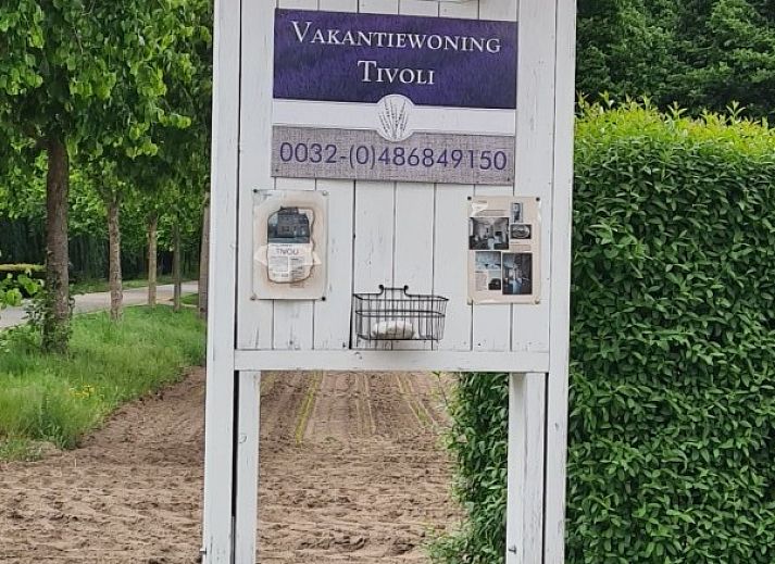 Enjoy the sunny patio at vacation home Tivoli in Dilsen-Stokkem, Limburg, Belgium, with comfortable outdoor seating and natural surroundings.