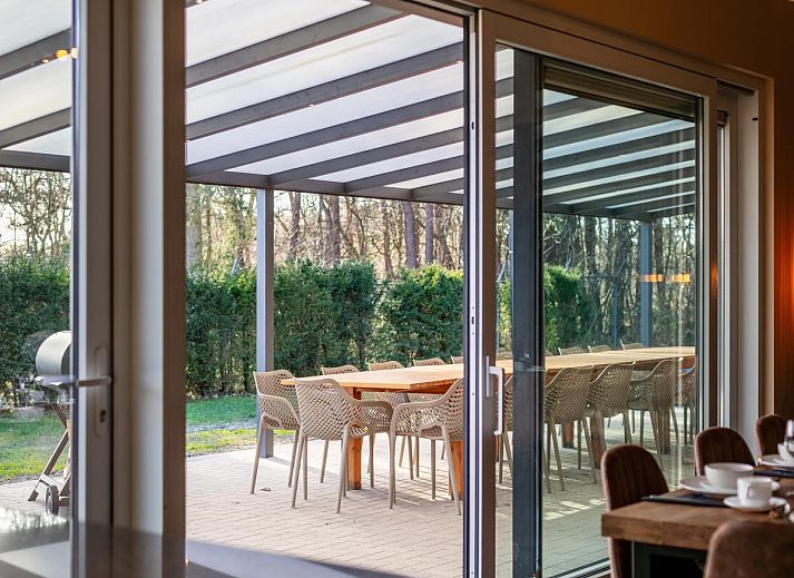 Stijlvolle eetruimte in vakantiehuis Ons Huis, Hechtel-Eksel, Limburg, Belgie met houten tafels en moderne verlichting.