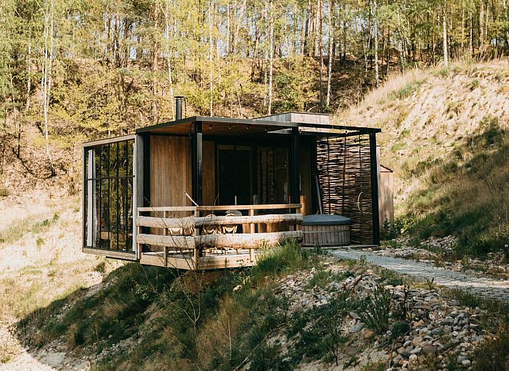 Binnenruimte van Watercabin met hottub in Neeroeteren, Limburg, Belgie met uitzicht op de natuur door grote ramen.
