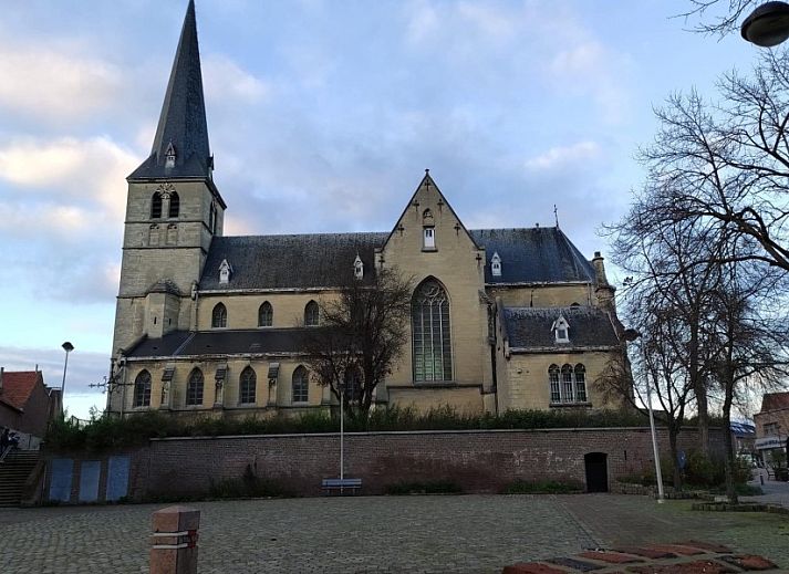 Gezellige zithoek bij 't Ouwershuys vakantiehuis in Opoeteren, Limburg, Belgie, met decoratieve muur en stoelen.