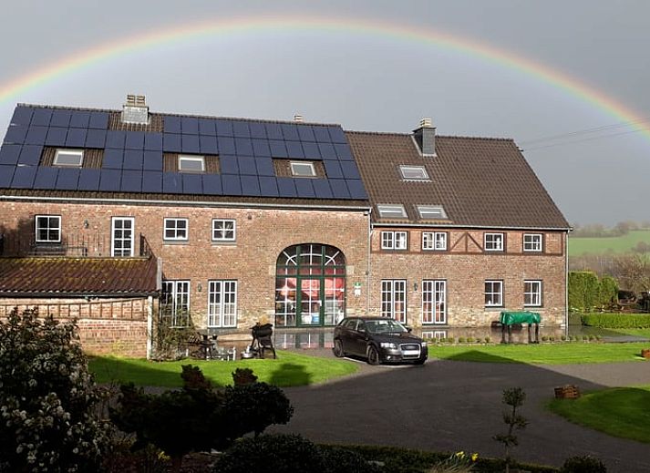 Modern kitchen in Holiday home in Hombourg, Ardennes, with wooden cabinets and dining area, ideal for a comfortable stay in Belgium.