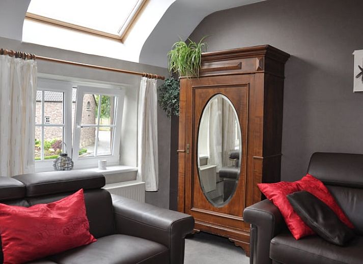 Cozy living room in Holiday Home in Hombourg, Ardennes, with comfortable sitting area and open kitchen, perfect for relaxation in Belgium.