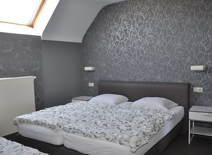 Cozy living room in Holiday Home in Hombourg, Ardennes, with comfortable sitting area and open kitchen, perfect for relaxation in Belgium.