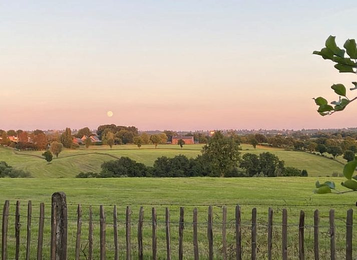 Charming Cottage in Aubel, bed and breakfast in the Ardennes, Belgium, with green garden and rustic brick facade.