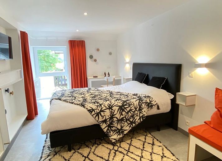 Charming Cottage in Aubel, bed and breakfast in the Ardennes, Belgium, with green garden and rustic brick facade.