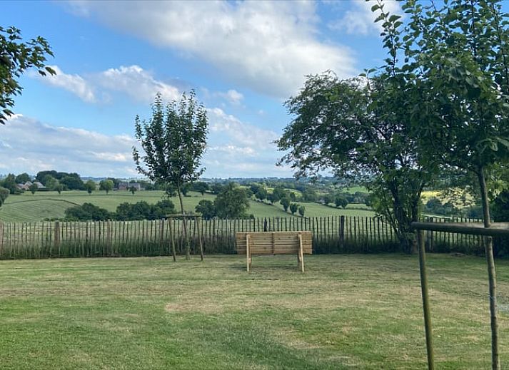 Charming Cottage in Aubel, bed and breakfast in the Ardennes, Belgium, with green garden and rustic brick facade.