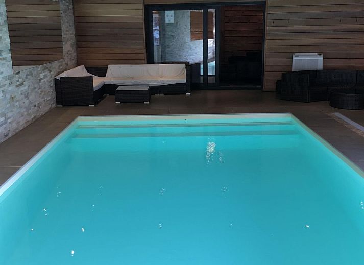 Cozy bedroom in Holiday Home Villa 'Marie France' Wellness, Stavelot, Ardennes, with authentic wooden interior and rustic ceiling.