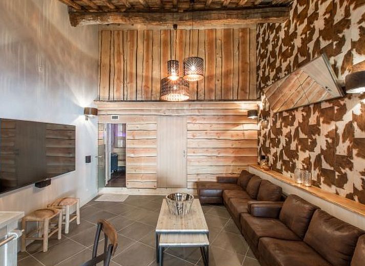 Cozy bedroom in Holiday Home Villa 'Marie France' Wellness, Stavelot, Ardennes, with authentic wooden interior and rustic ceiling.