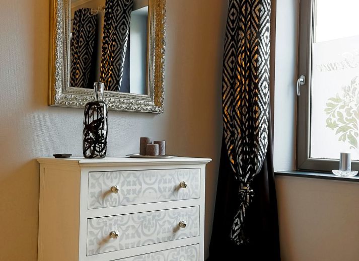 Cozy bedroom in Holiday Home Villa 'Marie France' Wellness, Stavelot, Ardennes, with authentic wooden bed and elegant chairs.