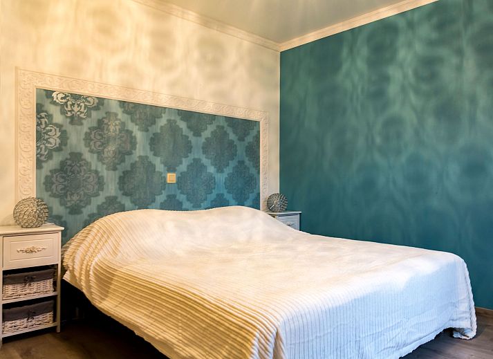 Charming interior of Holiday Home Villa 'Marie France' Wellness in Stavelot, Ardennes, with rustic wooden chest of drawers and decorations.